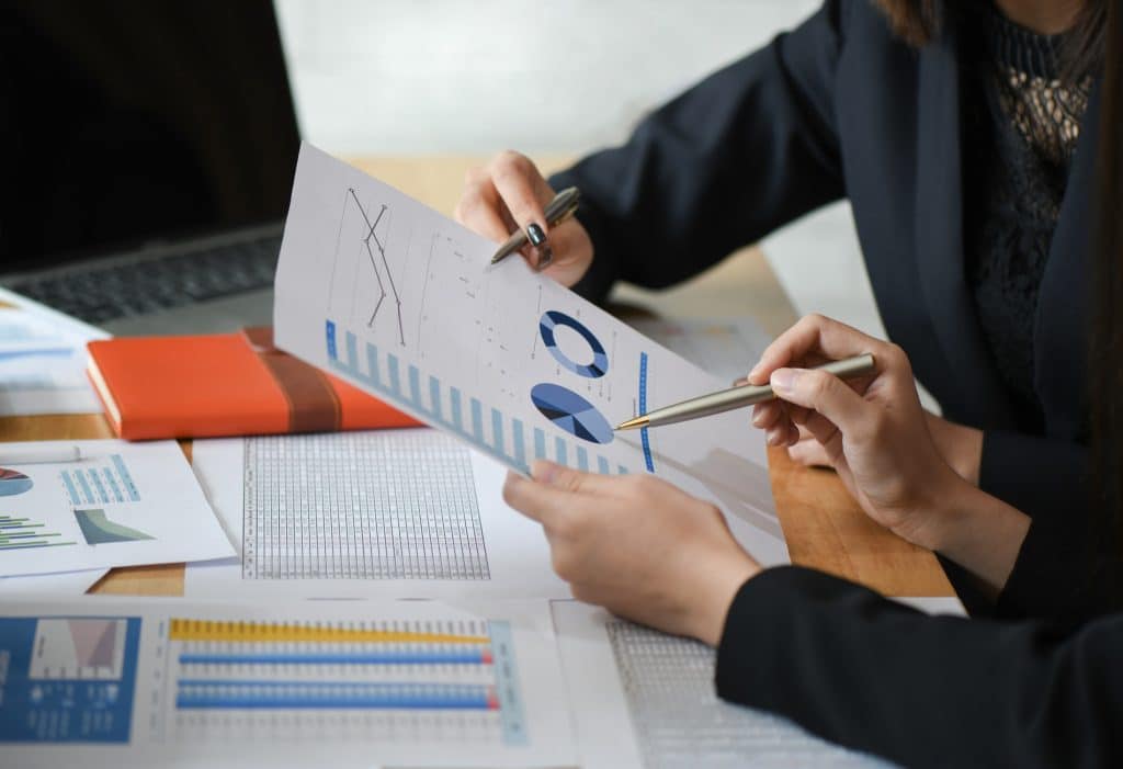 female accountant team is analyzing data documents in the office 1024x701 1